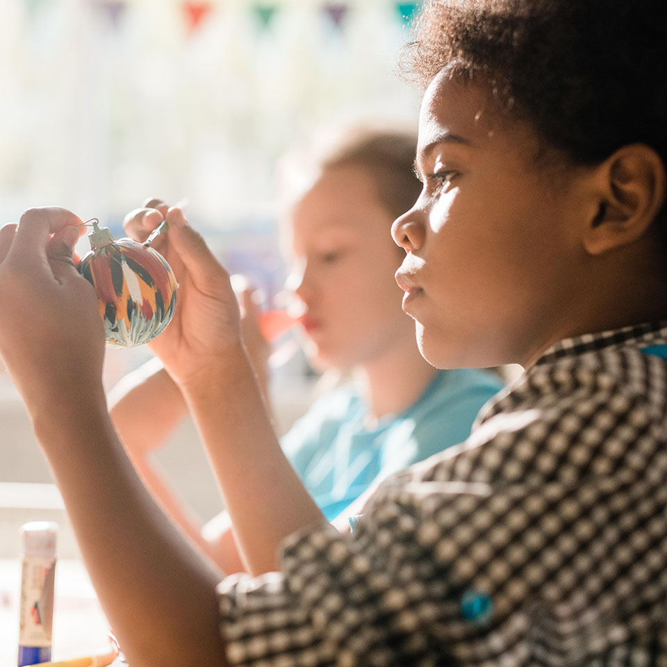 2A7F444 - Cute African schoolboy holding handmade decorative Christmas toy ball