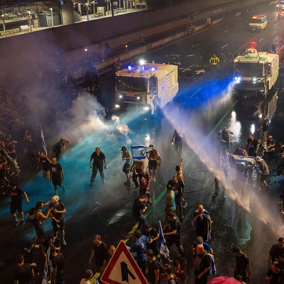 2RE2GRK - Riot police tries to clear demonstrators with a water canon during a protest against plans by Netanyahu's government to overhaul the judicial system, in Tel Aviv, Monday, July 24, 2023.
