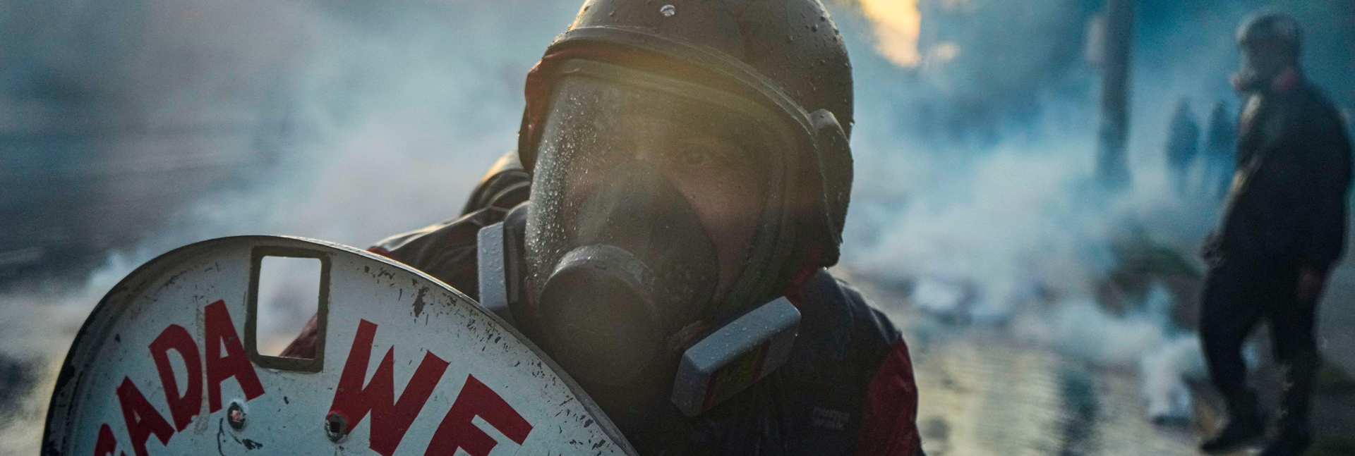 A volunteer first responder raises a shield during a protest commemorating the fifth anniversary of the most violent riots since the return of democracy in Santiago, Chile, Friday, Oct. 18, 2024