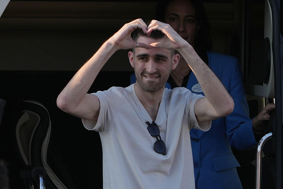 Freed Israeli hostage Avinatan Or gestures from a van as he arrives at Beilinson hospital in Petah Tikva, Israel, after he was released from Hamas captivity in the Gaza Strip