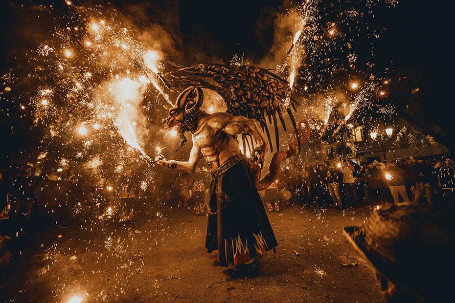 Atzeries, the fire beast, sets of its flying sparks during a “correfoc” in Barcelona's Gracia quarter.