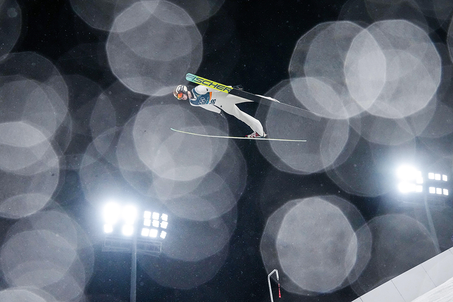 Kacper Tomasiak, of Poland, soars through the air during the ski jumping men's large hill individual at the 2026 Winter Olympics, in Predazzo, Italy
