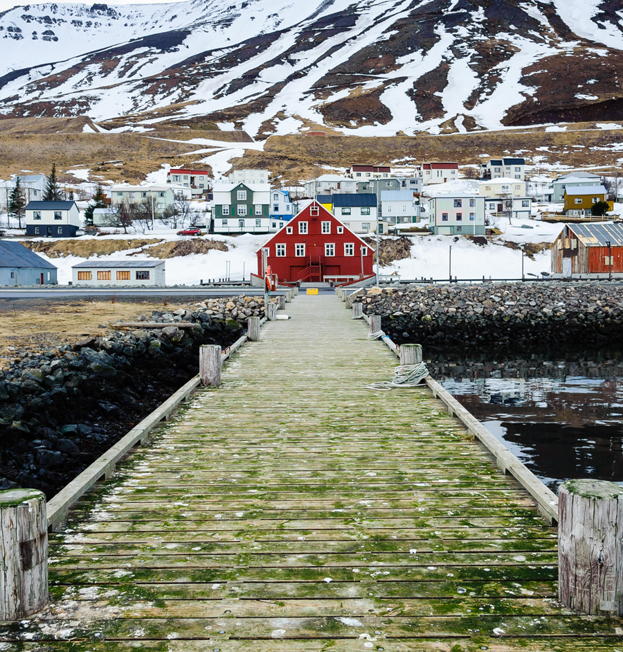 The picturesque town of Siglufjordur in northern Iceland is viewed from a pier
