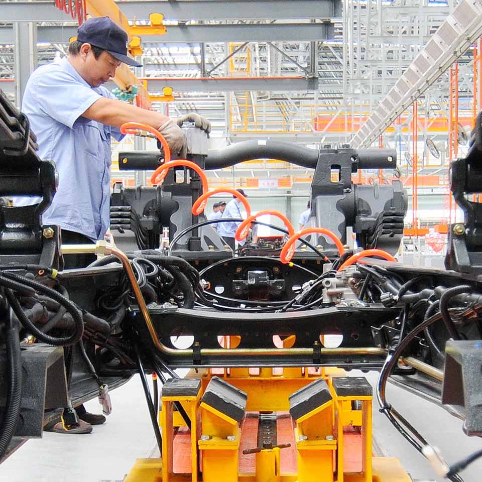 F37AKX - Workers install a heavy truck at a production base of Aviation Industry Corporation of China in Xingtai, north China's Hebei Province, Sept. 11, 2015.