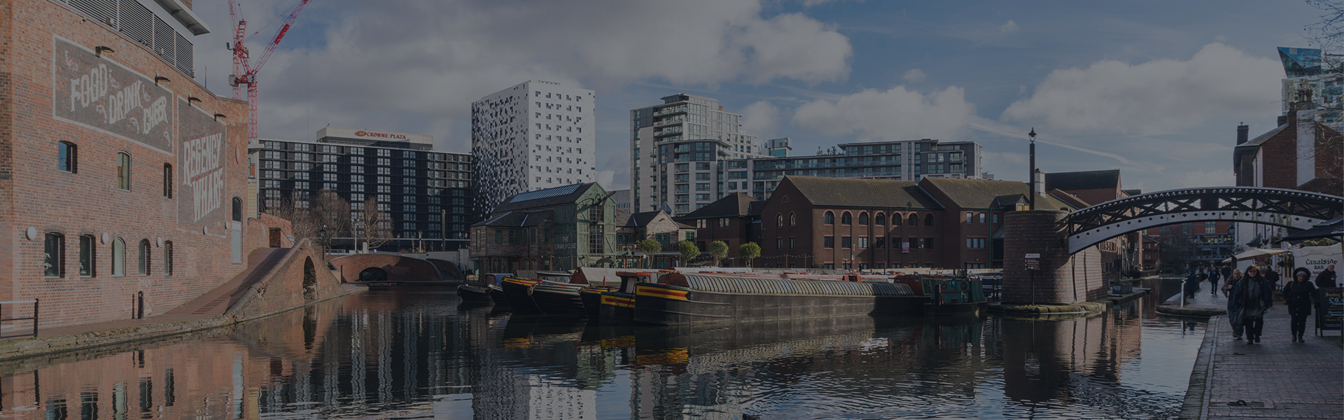 Views of the canal with reflections of people and buildings in Brindley Place Birmingham, UK
